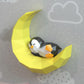 Penguin sleeping on moon